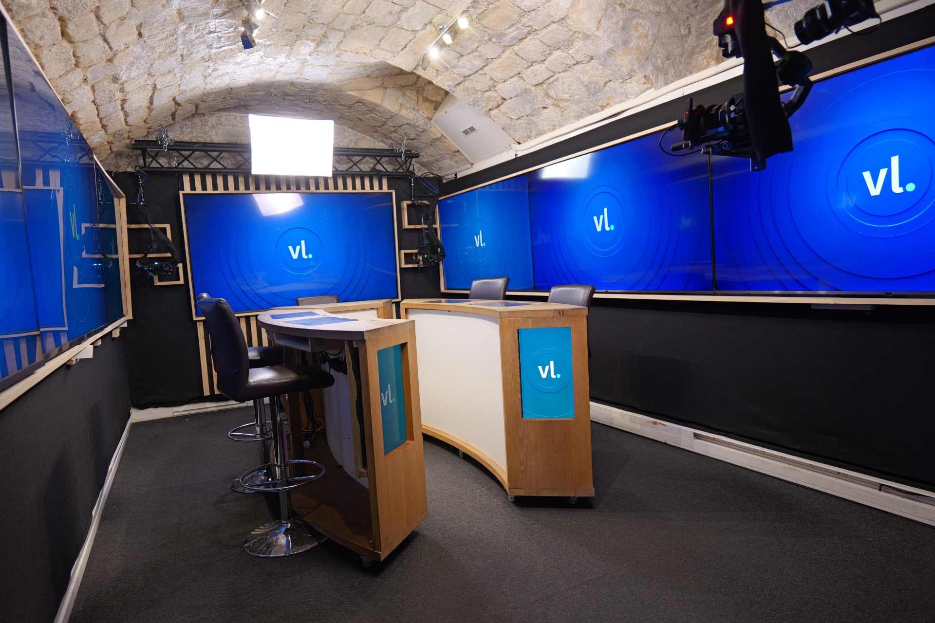 Plateau du studio audiovisuel à Paris avec écrans géants, pupitres et caméras broadcast